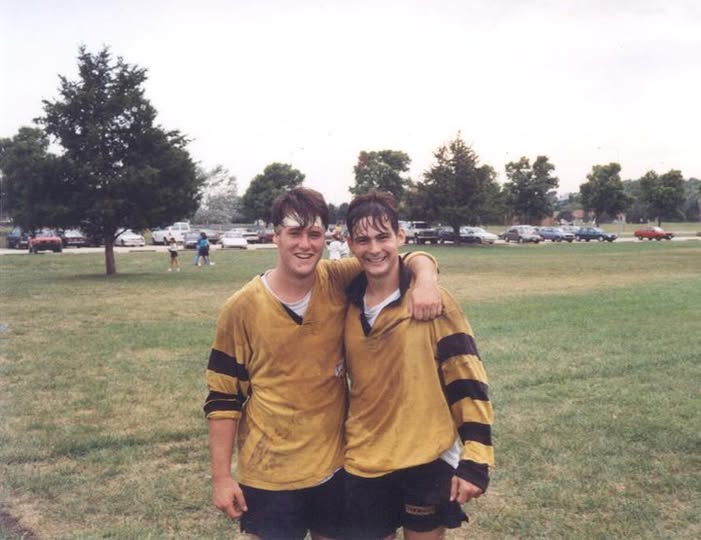 Ted Hughes and Nick Allen in Mizzou hooped jerseys with their arms around each other on the touchline