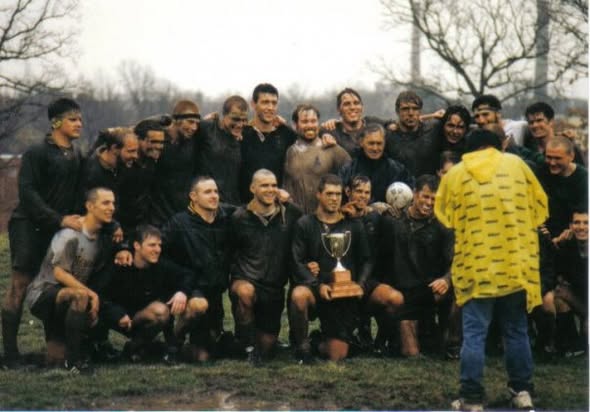 Muddy Mizzou players gathered with a trophy after the 1997 St. Louis Ruggerfest