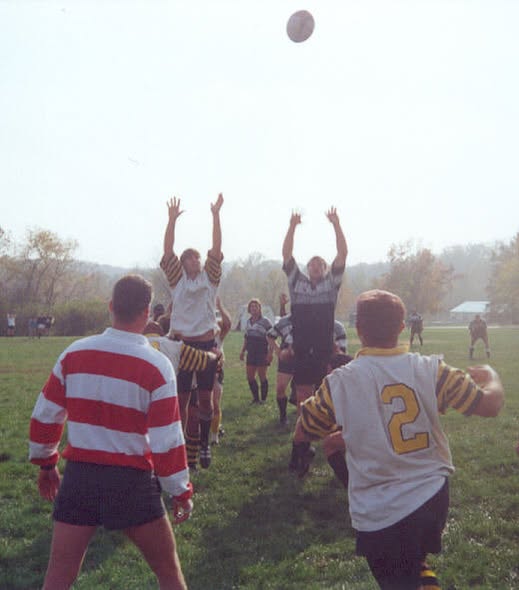 Mizzou and a side in red and white hooped jerseys contest a lineout on an autumn pitch