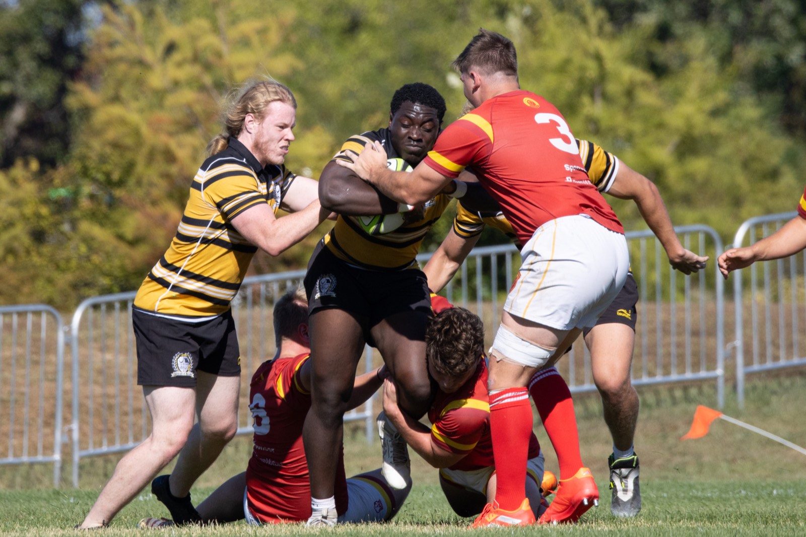 A Mizzou ball carrier is met by Iowa State defenders in red
