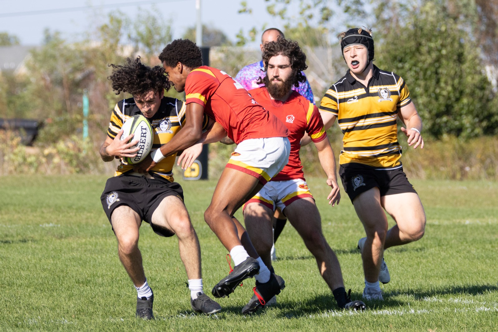 A Mizzou runner beats an Iowa State defender with the ball under one arm
