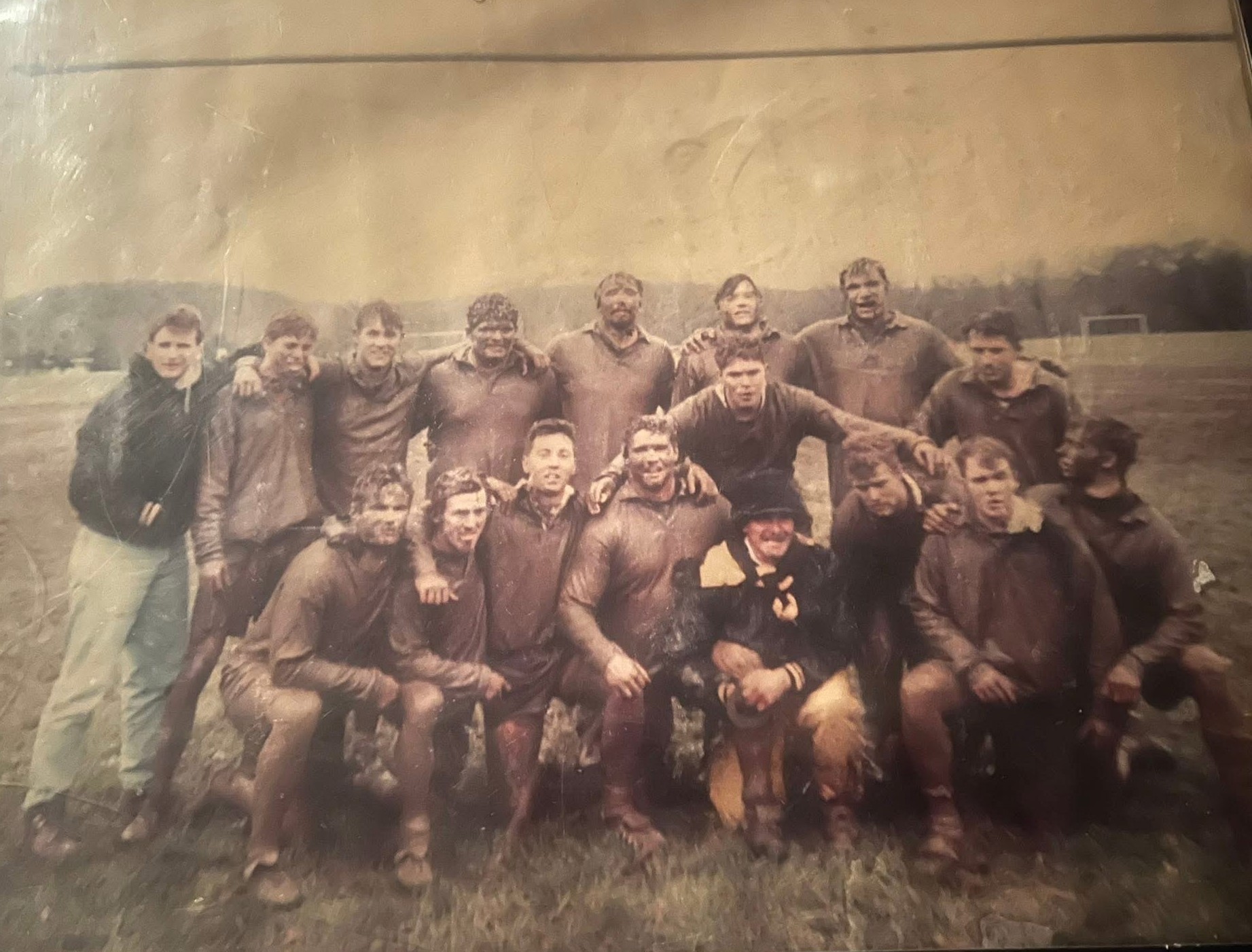 Mud-covered Mizzou rugby squad posing together after winning the 1993 Kansas City Collegiate Championship