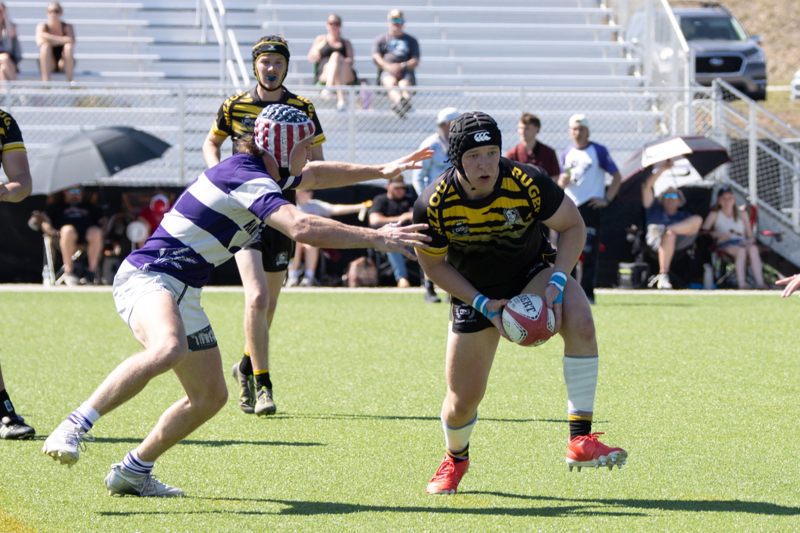 A Mizzou player takes on an opponent in purple and white hoops at the Classic City 7&rsquo;s