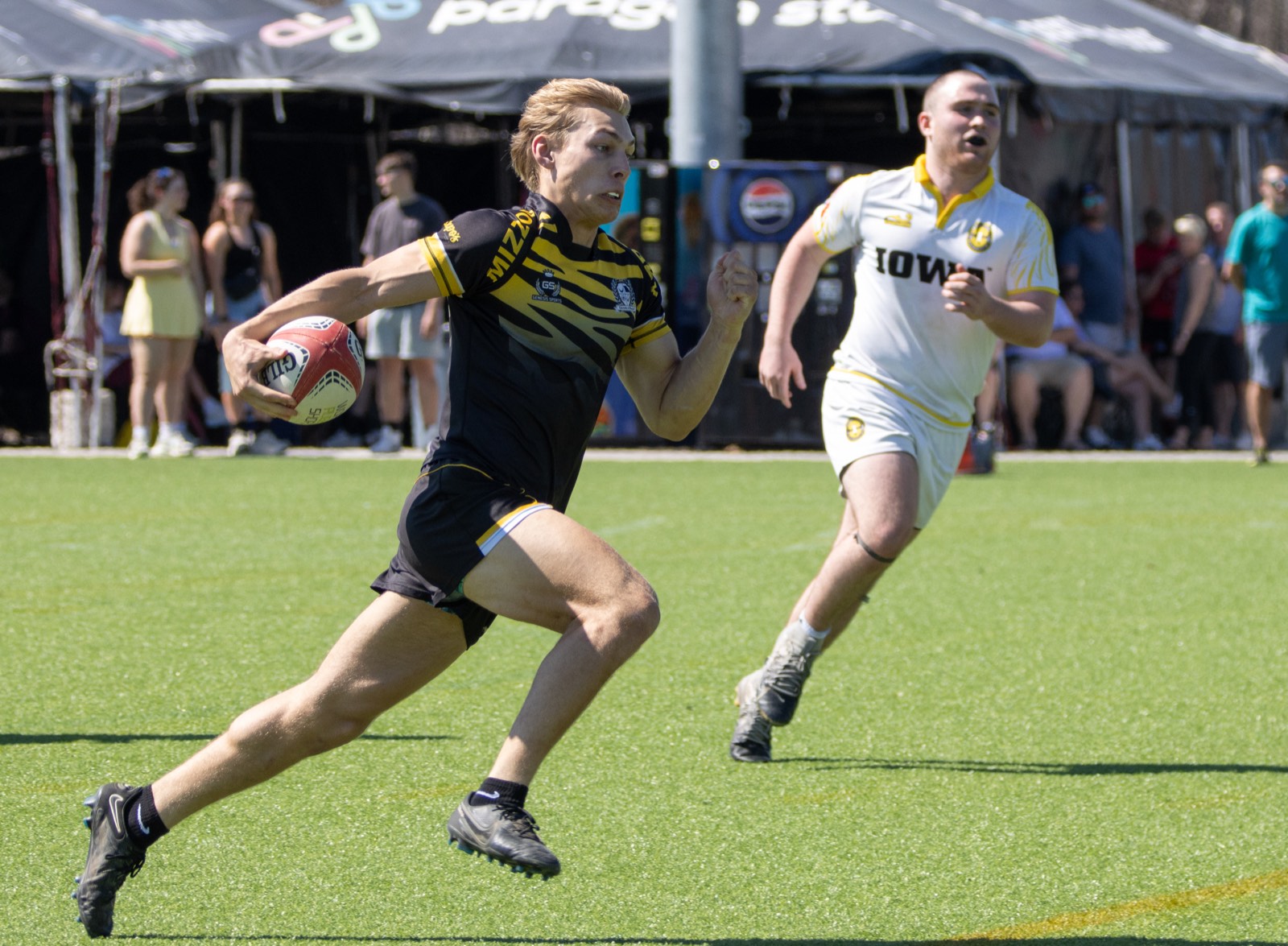 A Mizzou player accelerates past an Iowa opponent at the Classic City 7&rsquo;s