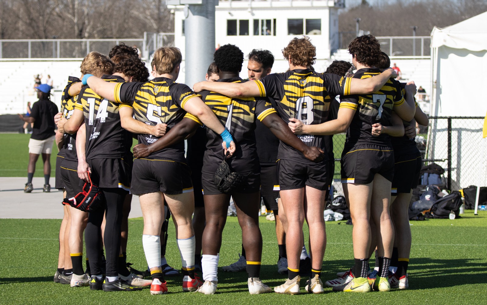 The Mizzou sevens squad huddled together on a turf pitch in spring 2026