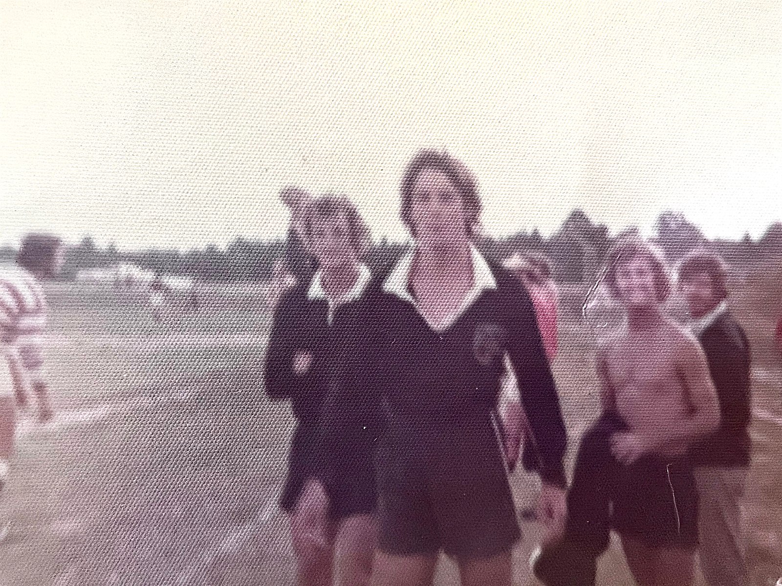 Faded and out-of-focus color snapshot of rugby players in dark jerseys with white collars crossing a field