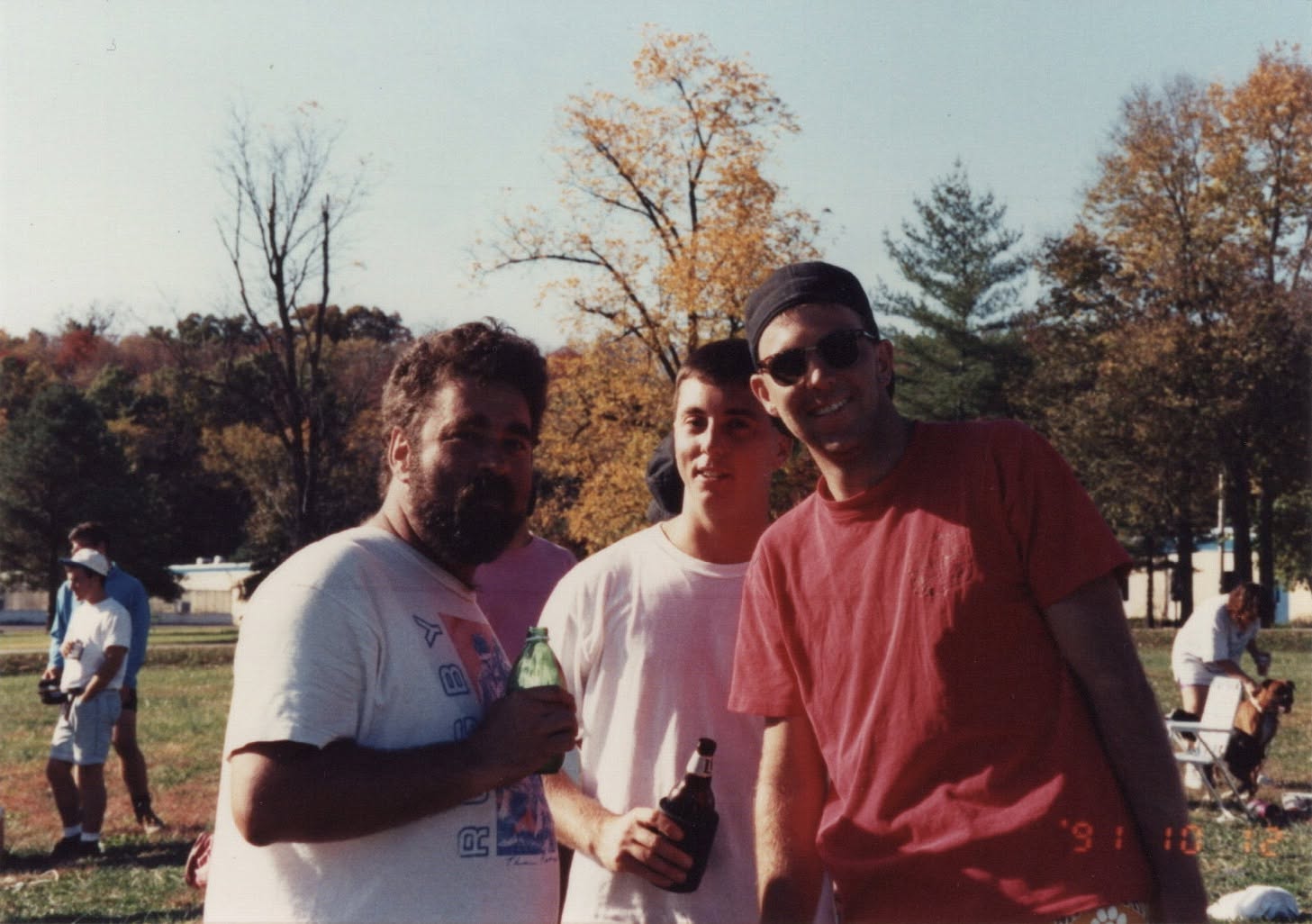 Doug Card, Tim Tajkowski and Chris Justice standing together beside the pitch