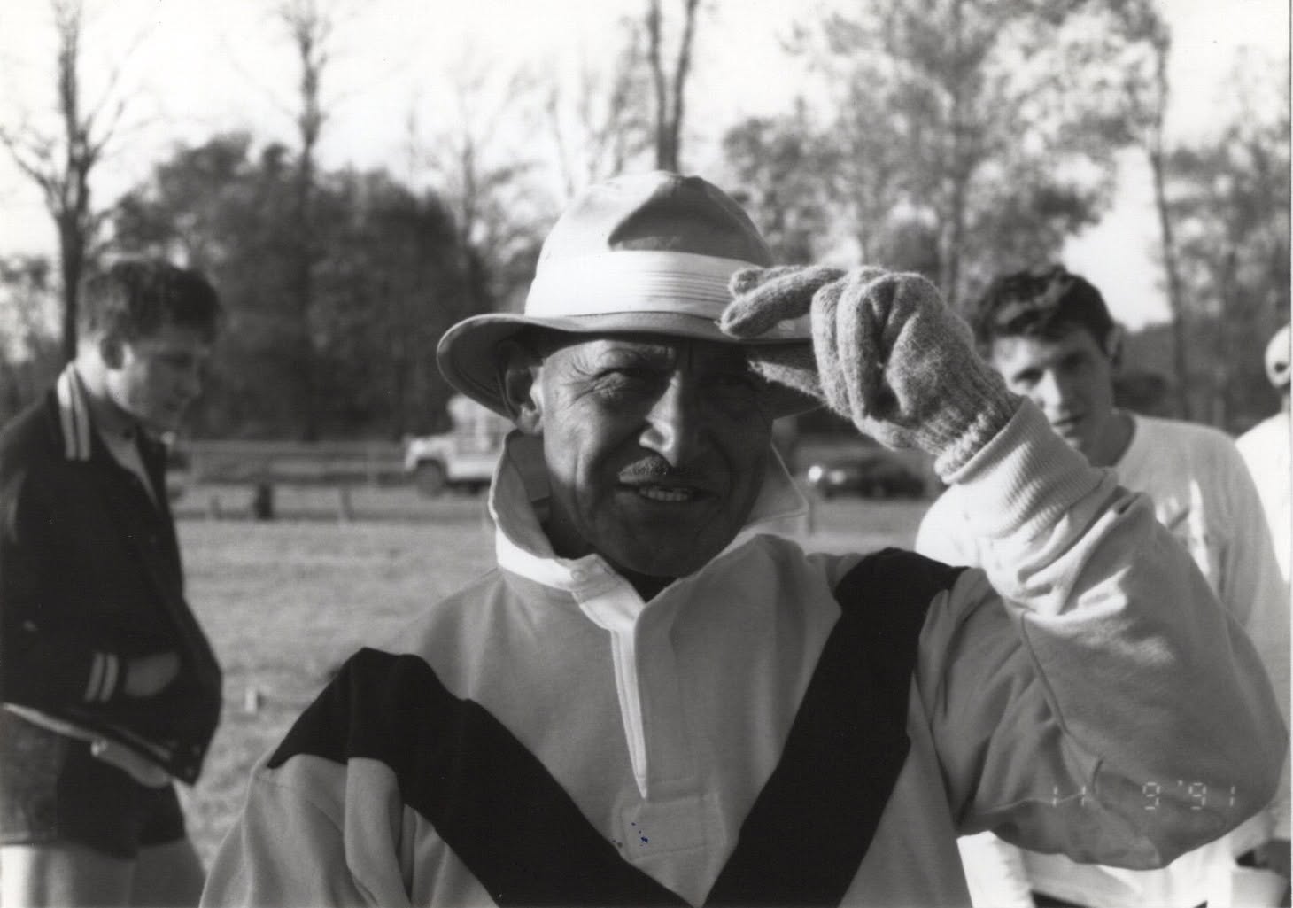 Coach Ian Hermann in a white hat on the touchline, black and white photograph