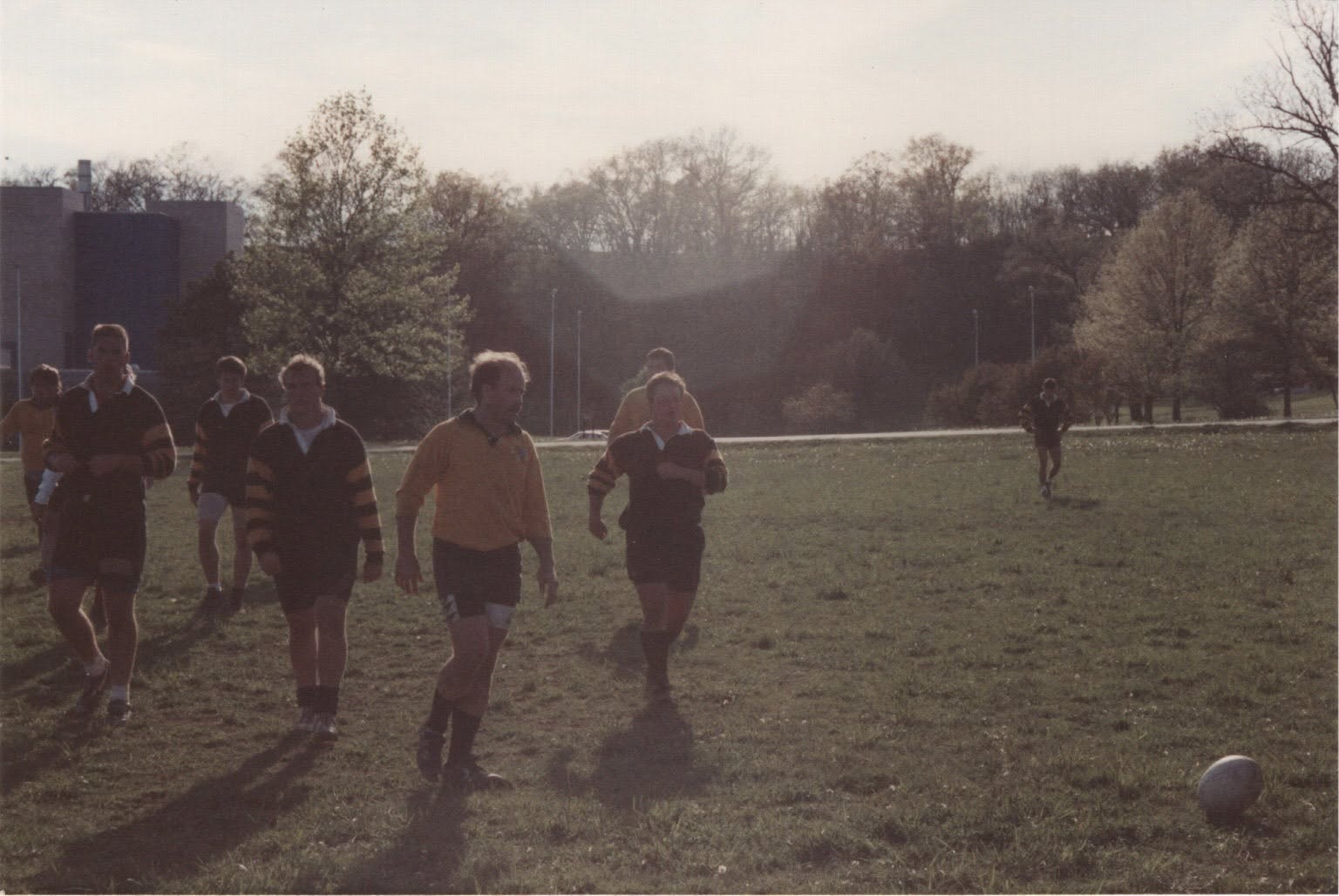Players walking toward the camera into low autumn sun