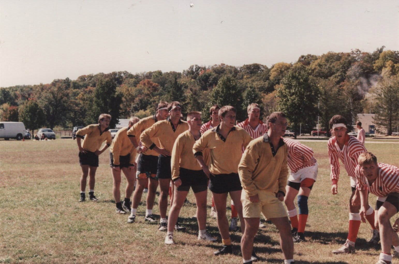 Two sides walk together across the pitch after a match