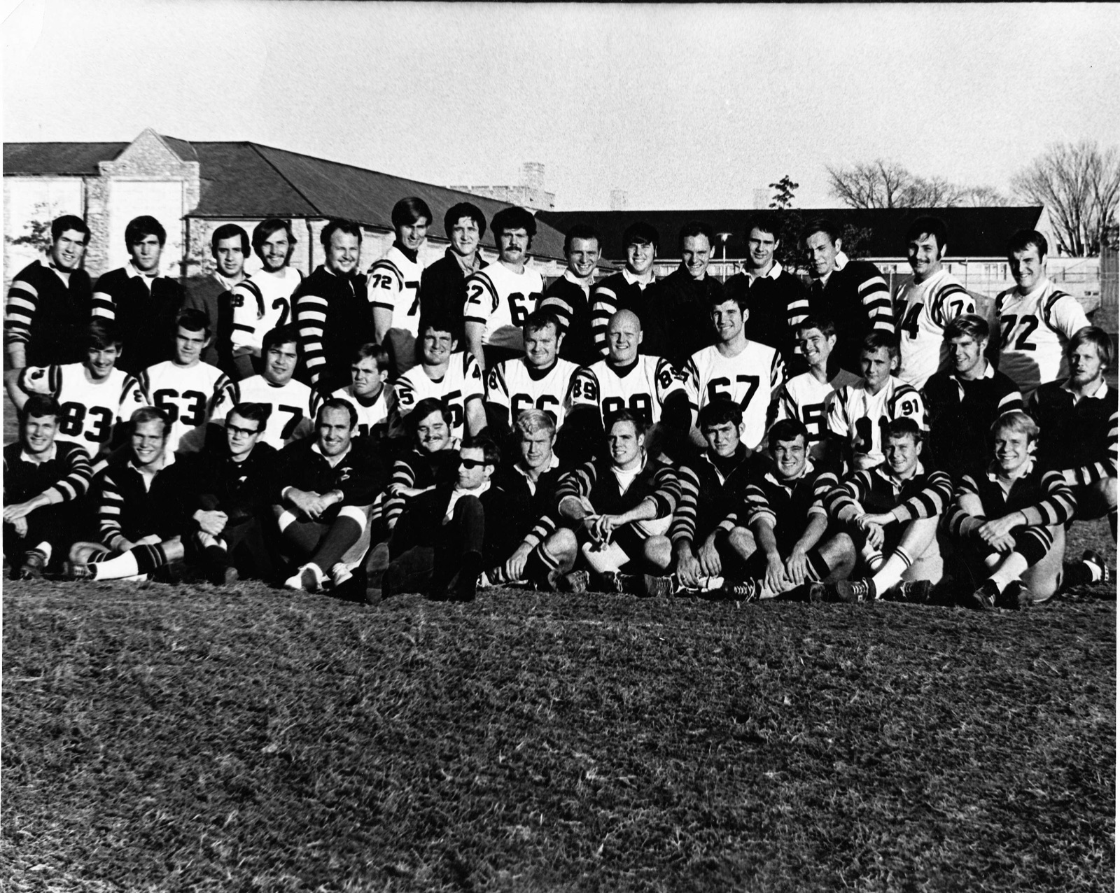 The full Fall 1968 Missouri University Rugby Club squad in black jerseys and donated white football jerseys
